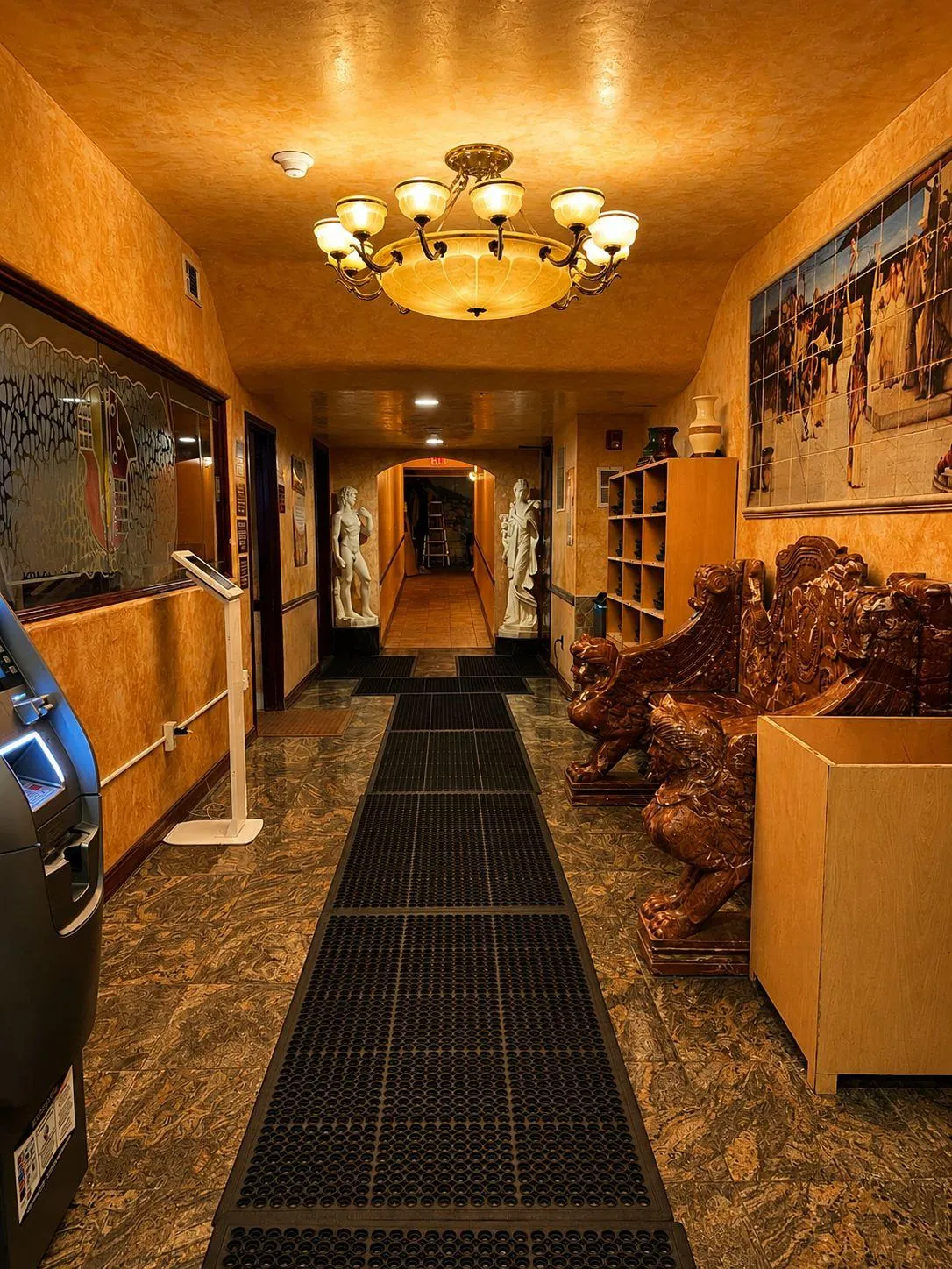 The long corridor from the lobby, statues at its far end.