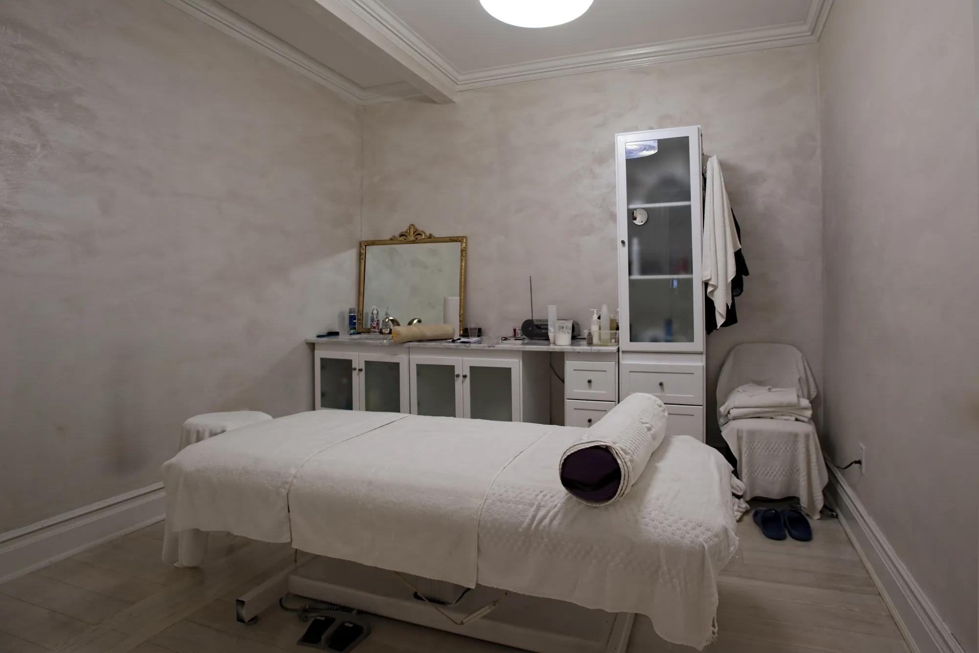 A treatment room with a vanity and cabinet.