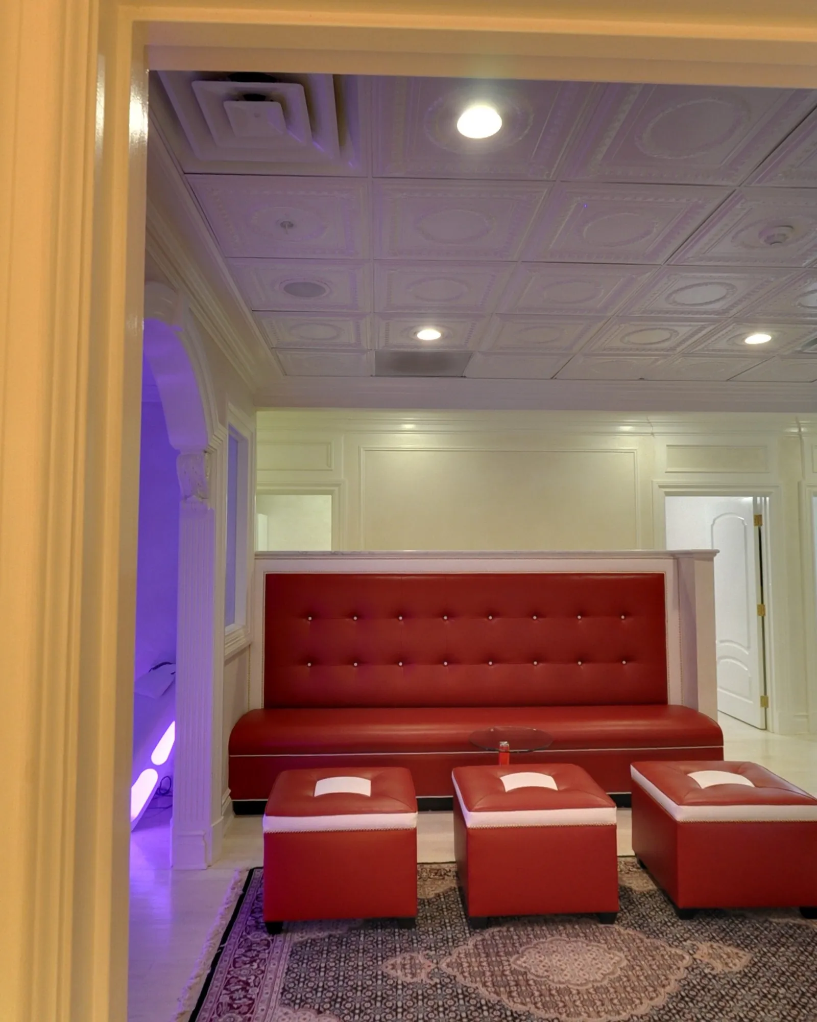 The salt room door, and the red banquette of the lounge beyond it.